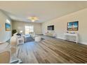 Inviting living room with hardwood floors, a ceiling fan, and large windows offering plenty of natural light at 4963 Old Highway 90, Conway, SC 29526