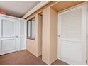 Hallway with doors and a window featuring neutral-toned walls and carpet at 100 Ocean Creek Dr. # L5, Myrtle Beach, SC 29572