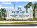Ocean Creek Plantation sign showcasing vacation rentals, oceanfront resort and conference center at 100 Ocean Creek Dr. # L5, Myrtle Beach, SC 29572