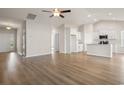 Open-concept living area with hardwood floors leading into the kitchen at 1203 Cypress Shoal Dr., Conway, SC 29526