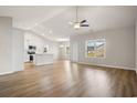Spacious living room with hardwood floors and lots of natural light, open to kitchen at 1203 Cypress Shoal Dr., Conway, SC 29526