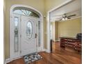 Welcoming foyer features a decorative front door, gleaming hardwood floors, and neutral paint at 2207 Wood Stork Dr., Conway, SC 29526