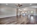 Bright and open living room showcasing wood floors, recessed lighting, and an open layout to kitchen at 2682 Hugo Rd., Conway, SC 29527
