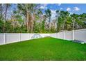 Fenced backyard with grassy area and playground structure at 570 Flowering Branch Ave., Little River, SC 29566