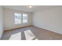 Bright bedroom with neutral walls and carpet, featuring two large windows at 885 Busy Corner Rd., Conway, SC 29527