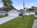 Nice curb appeal with a spacious driveway and American flag at 9659 Kings Grant Dr., Murrells Inlet, SC 29576