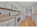 Functional kitchen with white appliances and cabinetry, offering a clean and bright cooking space at 1305 Conifer Ct., Murrells Inlet, SC 29576
