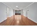 Open living room featuring hardwood floors, neutral paint, and a ceiling fan at 1305 Conifer Ct., Murrells Inlet, SC 29576