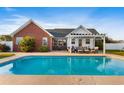 Gorgeous pool with a spacious patio, pergola, and ample seating, perfect for outdoor relaxation at 148 Highmeadow Ln., Aynor, SC 29511