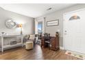 Inviting foyer with hardwood floors, chair, side table, and a charming entry door at 148 Highmeadow Ln., Aynor, SC 29511