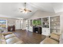 Bright living room with vaulted ceilings, built-in shelving, and comfortable seating at 148 Highmeadow Ln., Aynor, SC 29511