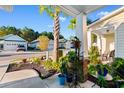 Inviting front porch with views of the neighborhood street, tropical landscaping, and neighboring homes at 1604 Carsens Ferry Dr., Conway, SC 29526