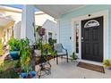 Cozy front porch featuring ample seating, decorative plants, and a welcoming entrance to this charming home at 1604 Carsens Ferry Dr., Conway, SC 29526