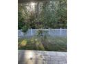 Serene backyard view featuring a white picket fence and mature trees at 323 Sea Turtle Dr., Myrtle Beach, SC 29588