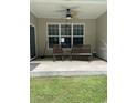 Relaxing covered patio with comfortable seating and a ceiling fan for warm days at 323 Sea Turtle Dr., Myrtle Beach, SC 29588