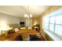 Well-lit dining area with a round wooden table, comfortable chairs, and a charming chandelier at 425 Spauldingwood Rd., Little River, SC 29566