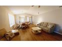 Spacious living and dining area featuring hardwood floors, a vaulted ceiling, and a large bay window at 425 Spauldingwood Rd., Little River, SC 29566