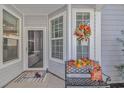Welcoming porch with fall decor, a bench, and a festive wreath adding charm to the entrance at 830 San Marco Ct. # C, Myrtle Beach, SC 29579
