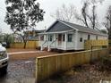Home's exterior shows fresh paint, landscaping, and a new fence for added privacy at 108 N Hazard St., Georgetown, SC 29440