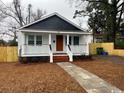 Inviting curb appeal with a well-maintained lawn and charming front porch at 108 N Hazard St., Georgetown, SC 29440
