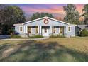 Inviting single-story home with a decorative wreath and well-maintained lawn at 1772 Bay Tree Ln., Surfside Beach, SC 29575