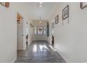 Hallway with wood floors leads to front door and other rooms at 1772 Bay Tree Ln., Surfside Beach, SC 29575