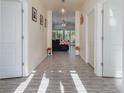 Bright hallway with hardwood floors leading to a living area with backyard views at 1772 Bay Tree Ln., Surfside Beach, SC 29575
