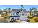 Beautiful two-story home with manicured lawn and attached two-car garage at 217 Astoria Park Loop, Conway, SC 29526