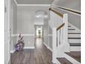 Elegant foyer featuring hardwood floors, staircase, and arched doorway at 217 Astoria Park Loop, Conway, SC 29526