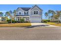 Inviting two-story home with a well-manicured lawn and attached two-car garage at 217 Astoria Park Loop, Conway, SC 29526