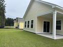 Backyard view featuring a covered patio with lush green grass at 3133 Tiger Tail Rd., Conway, SC 29526