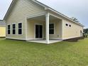 Backyard view featuring a covered patio with lush green grass at 3133 Tiger Tail Rd., Conway, SC 29526