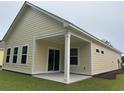 Backyard view featuring a covered patio with lush green grass at 3133 Tiger Tail Rd., Conway, SC 29526