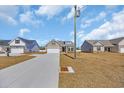 Street view showing the beautiful homes with driveways and well-maintained lawns at 432 Hallie Martin Rd., Conway, SC 29527