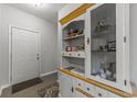Traditional hallway featuring hardwood floors, paneled front door, and built-in hutch with display shelving at 4818 Innisbrook Ct. # 603, Myrtle Beach, SC 29579