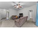 Open-concept living room featuring neutral carpet, a ceiling fan, and furniture arranged for easy conversation at 4818 Innisbrook Ct. # 603, Myrtle Beach, SC 29579