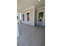 Inviting front porch featuring classic columns and a stylish entrance door with glass panels at 5118 Middleton View Dr., Myrtle Beach, SC 29579