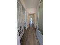 Bright hallway with wood flooring leading to various rooms, showcasing a spacious layout at 5118 Middleton View Dr., Myrtle Beach, SC 29579