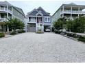 Beautiful raised beach home with hardi-plank siding and white stone driveway at 253 W Second Ave. S, Ocean Isle Beach, NC 28469