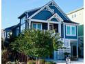 Attractive home with a front porch, white railings, and neatly landscaped yard, perfect for coastal living at 253 W Second Ave. S, Ocean Isle Beach, NC 28469