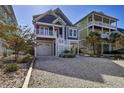 Charming raised beach home with a one-car garage and outdoor living space at 253 W Second Ave. S, Ocean Isle Beach, NC 28469