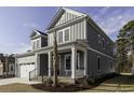 Attractive two-story home featuring an attached garage, front porch, and a well-maintained lawn at 3057 Moss Bridge Ln., Myrtle Beach, SC 29579