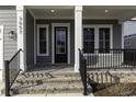 Inviting front porch with brick steps, decorative railing, and charming architectural details at 3057 Moss Bridge Ln., Myrtle Beach, SC 29579