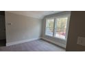 Bright bedroom with a window showcasing natural light, neutral walls, and plush carpeting, cozy and inviting at 681 Hawthorn Dr., Pawleys Island, SC 29585