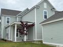 View of the home's back exterior featuring a detached garage, and a lovely outdoor space at 718 Macon Alley, Myrtle Beach, SC 29588
