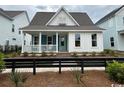 Quaint single-Gathering home with a charming front porch and stylish black fencing at 734 Macon Alley, Myrtle Beach, SC 29588