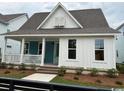 Attractive home with a welcoming porch, a combination of white and blue siding, and manicured landscaping at 734 Macon Alley, Myrtle Beach, SC 29588