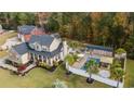Wide aerial view of a home showcasing an inground pool, multiple outbuildings, and lush landscaping at 104 Chapel Ridge Circle, Myrtle Beach, SC 29588