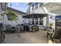 Private patio with hot tub, umbrella, and seating at 2523 Blue Crane Circle # 102, Myrtle Beach, SC 29577