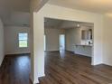 Spacious living room featuring hardwood floors, neutral walls, and an open layout at 323 Palmetto Sand Loop, Conway, SC 29527